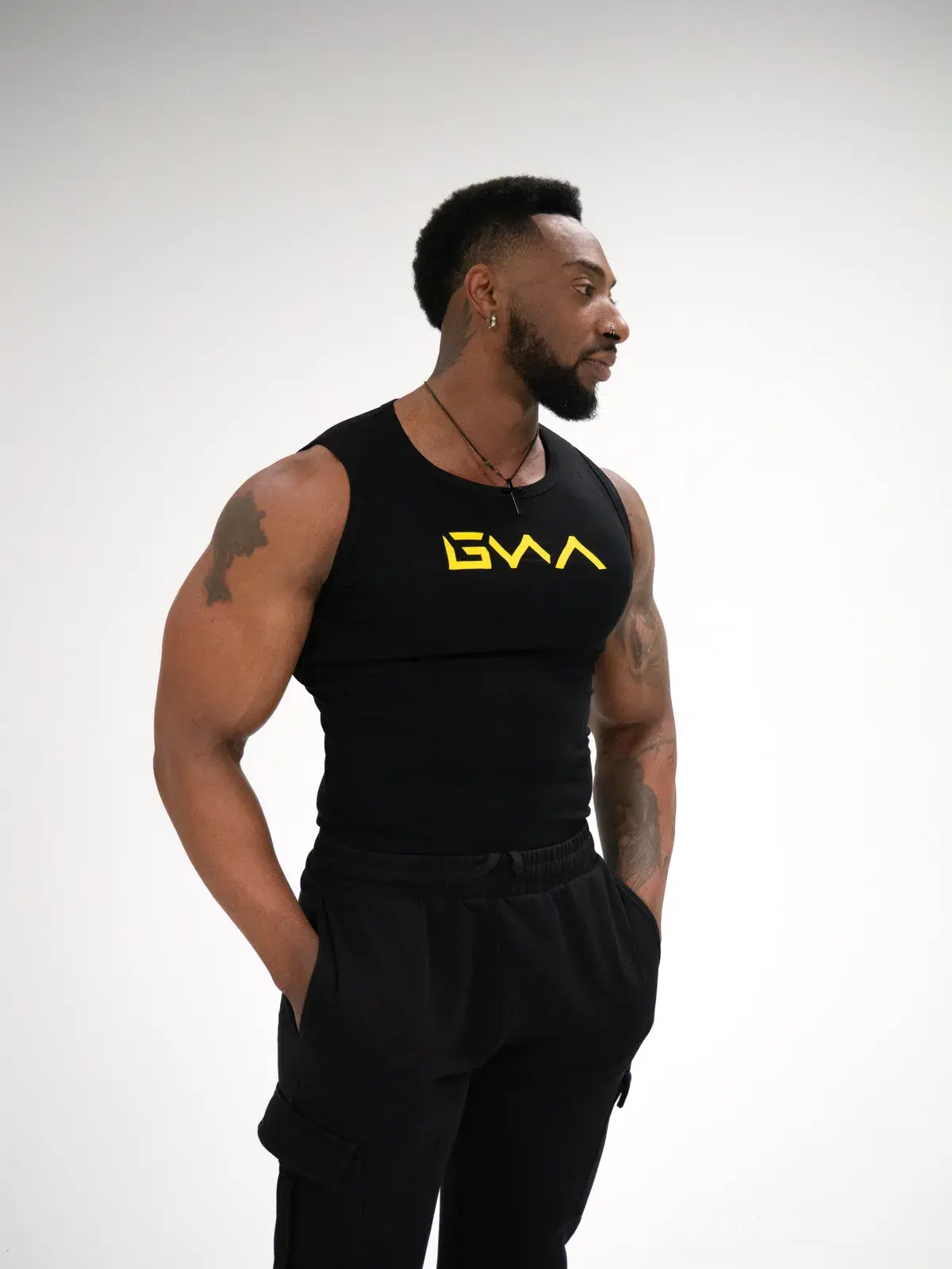 A model wearing the men's GWA Rep tank from the launch collection
